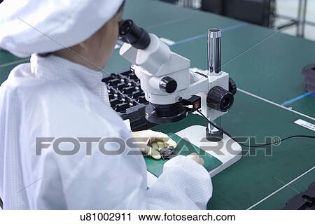 Worker using microscope in factory that specialises in creating functional circuits on flexible surfaces View Large Photo Image Stock Image - Worker using microscope in factory that specialises in creating functional circuits on flexible surfaces. Fotosearch