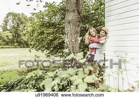 Young couple hugging in garden View Large Photo Image Stock Photograph - Young couple hugging in garden. Fotosearch