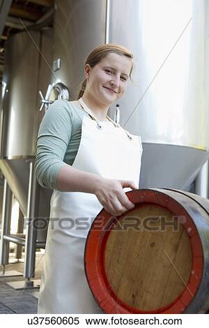 Stock Photography - Young woman carrying beer barrel. Fotosearch