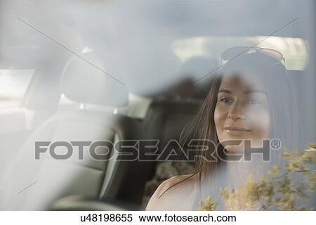 Stock Photography - Young woman driving car. Fotosearch