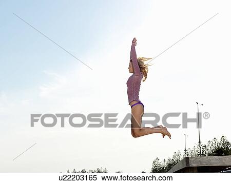 "Young woman jumping from beach pier, Altona, Melbourne, Victoria, Australia" View Large Photo Image Stock Photography - "Young woman jumping from beach pier, Altona, Melbourne, Victoria, Australia". Fotosearch