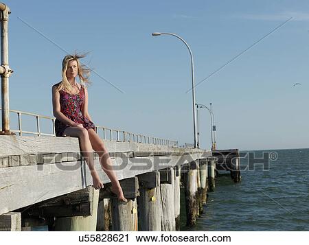 "Young woman sitting on breezy pier, Altona, Melbourne, Victoria, Australia" View Large Photo Image Stock Image - "Young woman sitting on breezy pier, Altona, Melbourne, Victoria, Australia". Fotosearch