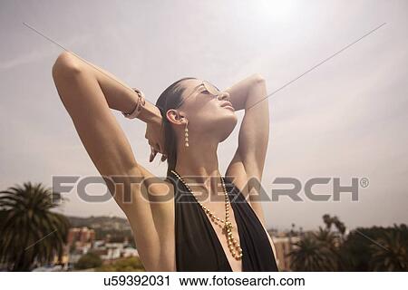 "Young woman with hands in hair, portrait" View Large Photo Image Stock Image - "Young woman with hands in hair, portrait". Fotosearch