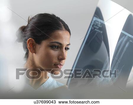 Stock Image - Doctor examining an X-ray. Fotosearch