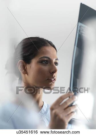 Doctor examining an X-ray View Large Photo Image Stock Photograph - Doctor examining an X-ray. Fotosearch