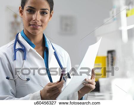 Doctor holding a blood sample View Large Photo Image Stock Photo - Doctor holding a blood sample. Fotosearch