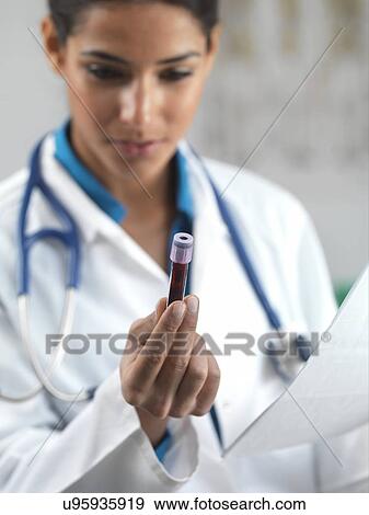 Stock Photo - Doctor holding a blood sample. Fotosearch