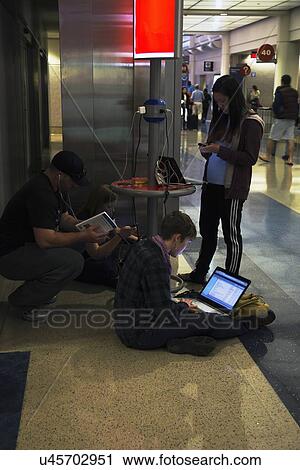 "Airport travelers charging their battaries for computers, ipad and cell phones, airport" View Large Photo Image Stock Image - "Airport travelers charging their battaries for computers, ipad and cell phones, airport". Fotosearch