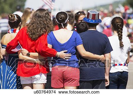 Picture - "Backs of women pose for picture, July 4, Independence Day Parade, Telluride, Colorado, USA". Fotosearch