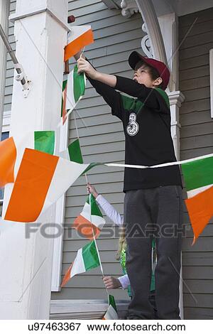 Stock Photo - "Boy displays Irish flag, St. Patrick's Day Parade, 2014, South Boston, Massachusetts, USA". Fotosearch