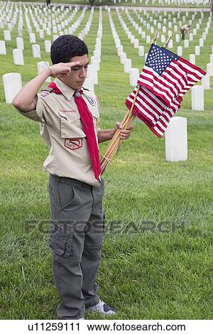 Stock Image - "Boyscout salutes at one of 85, 000 US Flags at 2014 Memorial Day Event, Los Angeles National Cemetery, California, USA". Fotosearch
