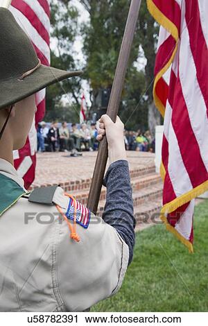 Stock Image - "Boyscouts display US Flag at solemn 2014 Memorial Day Event, Los Angeles National Cemetery, California, USA". Fotosearch