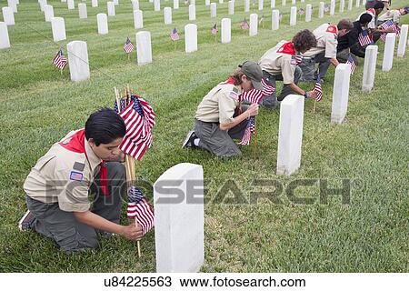 Stock Image - "Boyscouts placing one of 85, 000 US Flags at 2014 Memorial Day Event, Los Angeles National Cemetery, California, USA". Fotosearch