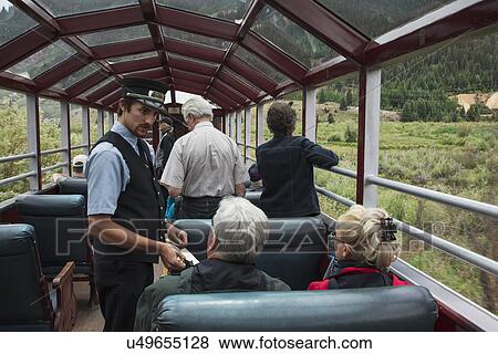 "Brakeman takes tickes on Durango and Silverton Narrow Gauge Railroad featuring Steam Engine Train ride, Colorado, USA" View Large Photo Image Stock Photo - "Brakeman takes tickes on Durango and Silverton Narrow Gauge Railroad featuring Steam Engine Train ride, Colorado, USA". Fotosearch
