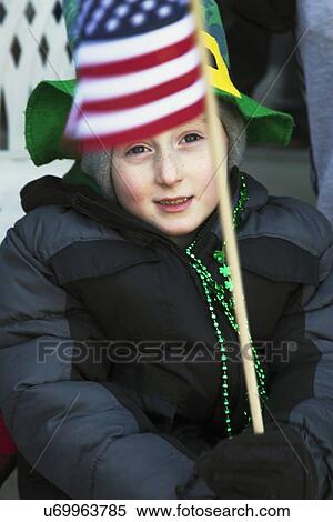 Stock Photography - "Child holds US Flag, St. Patrick's Day Parade, 2014, South Boston, Massachusetts, USA". Fotosearch