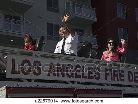 Picture - "Chinese-American LA Fire Dept waves at 115th Golden Dragon Parade, Chinese New Year, 2014, Year of the Horse, Los Angeles, California, USA". Fotosearch