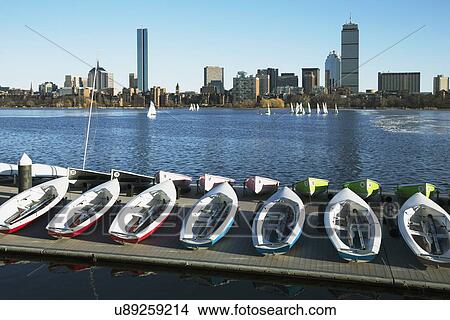 Picture - "Colorful docked sailboats and Boston Skyline in winter on half frozen Charles River, Massachusetts, USA". Fotosearch