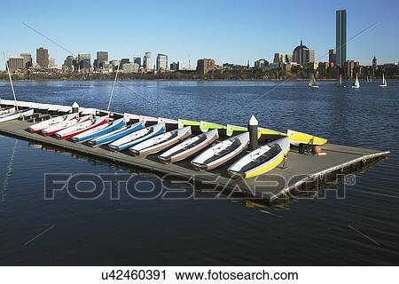 "Colorful docked sailboats and Boston Skyline in winter on half frozen Charles River, Massachusetts, USA" View Large Photo Image Stock Image - "Colorful docked sailboats and Boston Skyline in winter on half frozen Charles River, Massachusetts, USA". Fotosearch