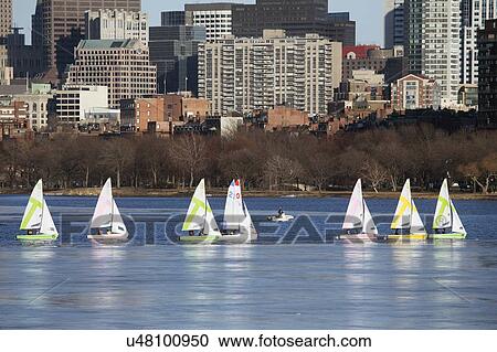 "Colorful docked sailboats and Boston Skyline in winter on half frozen Charles River, Massachusetts, USA" View Large Photo Image Stock Image - "Colorful docked sailboats and Boston Skyline in winter on half frozen Charles River, Massachusetts, USA". Fotosearch