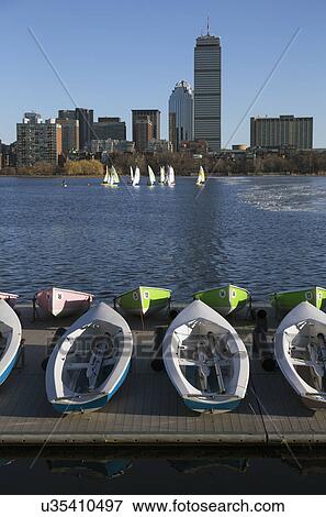 Stock Photo - "Colorful docked sailboats and Boston Skyline in winter on half frozen Charles River, Massachusetts, USA". Fotosearch
