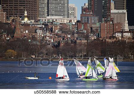 "Colorful docked sailboats and Boston Skyline in winter on half frozen Charles River, Massachusetts, USA" View Large Photo Image Stock Photo - "Colorful docked sailboats and Boston Skyline in winter on half frozen Charles River, Massachusetts, USA". Fotosearch