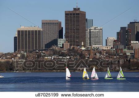 "Colorful docked sailboats and Boston Skyline in winter on half frozen Charles River, Massachusetts, USA" View Large Photo Image Stock Photo - "Colorful docked sailboats and Boston Skyline in winter on half frozen Charles River, Massachusetts, USA". Fotosearch
