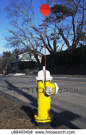 Stock Photo - "Colorful yellow fire hydrent and red flag in Marblehead, Massachusetts, USA". Fotosearch
