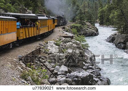 "Durango and Silverton Narrow Gauge Railroad Steam Engine travels along Animas River, Colorado, USA" View Large Photo Image Stock Image - "Durango and Silverton Narrow Gauge Railroad Steam Engine travels along Animas River, Colorado, USA". Fotosearch
