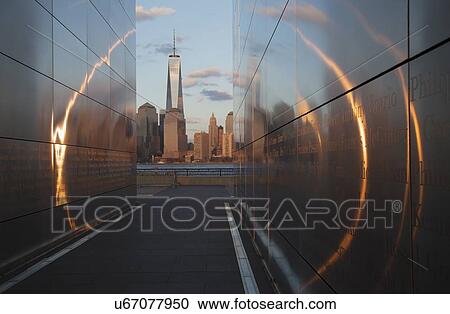 "Empty Sky: Jersey City 9/11 Memorial at sunset shows One World Trade Center (1WTC), Freedom Tower through golden circle of light, New Jersey, USA" View Large Photo Image Stock Image - "Empty Sky: Jersey City 9/11 Memorial at sunset shows One World Trade Center (1WTC), Freedom Tower through golden circle of light, New Jersey, USA". Fotosearch