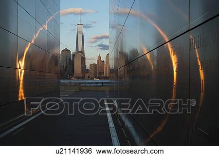 "Empty Sky: Jersey City 9/11 Memorial at sunset shows One World Trade Center (1WTC), Freedom Tower through golden circle of light, New Jersey, USA" View Large Photo Image Stock Photograph - "Empty Sky: Jersey City 9/11 Memorial at sunset shows One World Trade Center (1WTC), Freedom Tower through golden circle of light, New Jersey, USA". Fotosearch