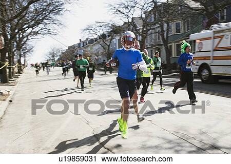 Stock Image - "Joggers, South Boston, St. Patrick's Day Road Race, South Boston, Massachusetts, USA". Fotosearch
