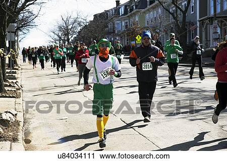 Stock Image - "Joggers, South Boston, St. Patrick's Day Road Race, South Boston, Massachusetts, USA". Fotosearch