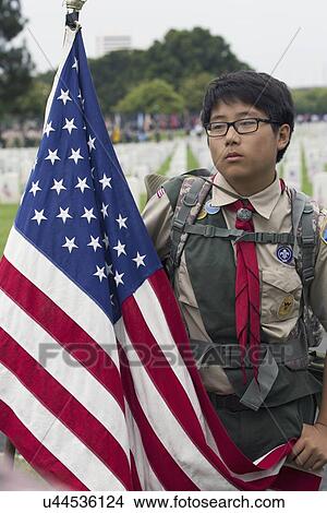 Picture - "Korean American Boyscout and US Flag at 2014 Memorial Day Event, Los Angeles National Cemetery, California, USA". Fotosearch