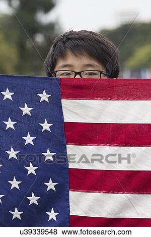 Stock Photo - "Korean American Boyscout and US Flag at 2014 Memorial Day Event, Los Angeles National Cemetery, California, USA". Fotosearch