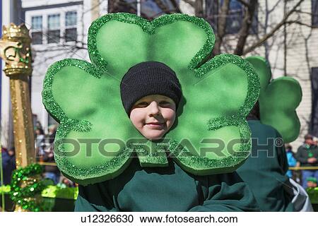 Stock Image - "Little boy and green cloverleaf, St. Patrick's Day Parade, 2014, South Boston, Massachusetts, USA". Fotosearch