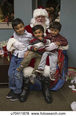 Stock Photo - "Little boys sit on Santa's lap at Christmas dinner for US Soldiers at Wounded Warrior Center, Camp Pendleton, North of San Diego, California, USA". Fotosearch
