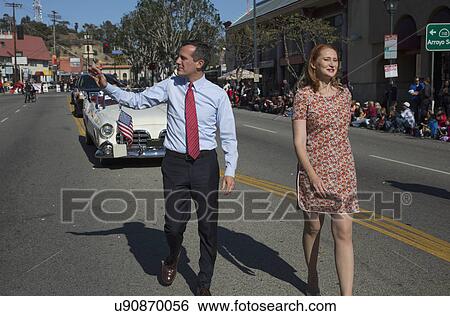 Stock Photograph - "Los Angeles Mayor Eric Garcetti and wife, Jacque McMillan march in 115th Golden Dragon Parade, Chinese New Year, Los Angeles, California, USA". Fotosearch
