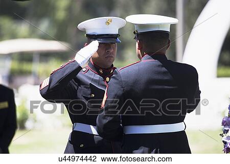 Stock Image - "Marine folds flag at Memorial Service for fallen US Soldier, PFC Zach Suarez, ""Honor Mission"" on Highway 23, drive to Memorial Service, Westlake Village, California, USA". Fotosearch