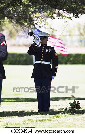 Picture - "Marine playing taps at Memorial Service for fallen US Soldier, PFC Zach Suarez, ""Honor Mission"" on Highway 23, drive to Memorial Service, Westlake Village, California, USA". Fotosearch