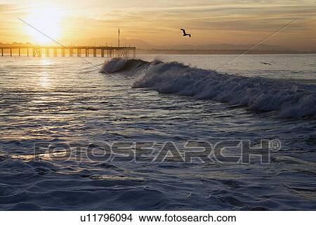 Picture - "Ocean waves at sunrise with Ventura Pier, Ventura, California, USA". Fotosearch