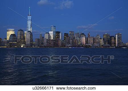 Stock Image - "Panoramic view of New York City Skyline at dusk featuring One World Trade Center (1WTC), Freedom Tower, New York City, New York, USA". Fotosearch