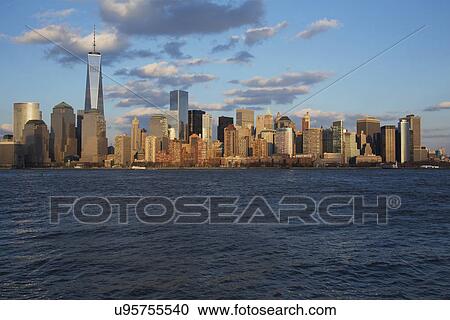 Stock Image - "Panoramic view of New York City Skyline on water featuring One World Trade Center (1WTC), Freedom Tower, New York City, New York, USA". Fotosearch