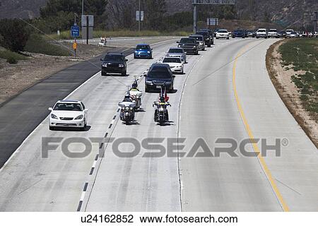 Stock Image - "Patriot Guard Motorcyclists honoring fallen US Soldier, PFC Zach Suarez, ""Honor Mission"" on Highway 23, drive to Memorial Service, Westlake Village, California, USA". Fotosearch