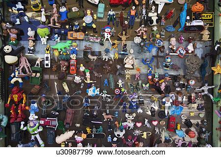 Stock Photo - "Plastic chotskies toys of super heroes, cars displayed in window, Ventura, California, USA". Fotosearch