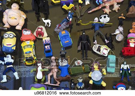 Stock Photograph - "Plastic chotskies toys of super heroes, cars displayed in window, Ventura, California, USA". Fotosearch