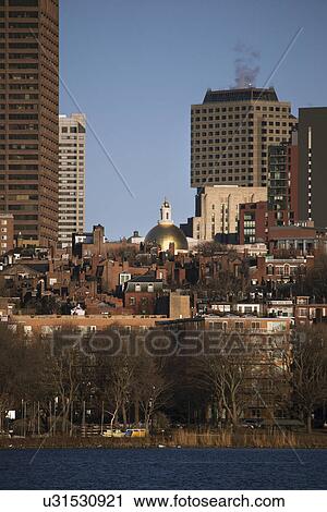 Stock Image - "Prudential Building, State House and Boston Skyline in winter on half frozen Charles River, Massachusetts, USA". Fotosearch