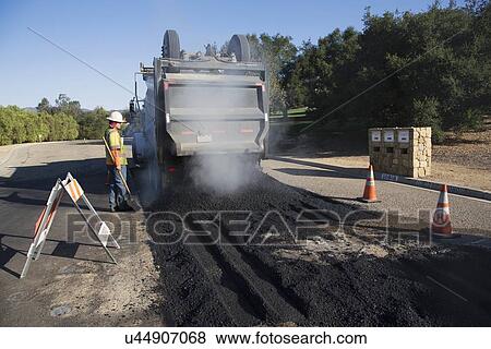 "Roadworker repaves road with steam, Encino Drive, Oak View, California, USA" View Large Photo Image Stock Photo - "Roadworker repaves road with steam, Encino Drive, Oak View, California, USA". Fotosearch