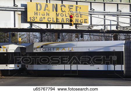 "Sign saying ""Danger High Voltage"" and NJ Light Rail Transit, Jersey City, New Jersey, USA" View Large Photo Image Picture - "Sign saying ""Danger High Voltage"" and NJ Light Rail Transit, Jersey City, New Jersey, USA". Fotosearch