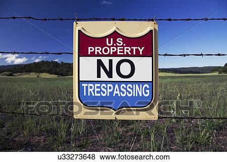 Stock Photo - "Sign states US Property, NO TRESPASSING, Ojai, California, USA". Fotosearch