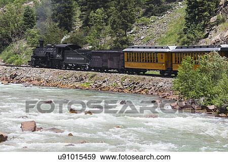 "The Durango and Silverton Narrow Gauge Railroad Steam Engine travels along Animas River, Colorado, USA" View Large Photo Image Stock Photo - "The Durango and Silverton Narrow Gauge Railroad Steam Engine travels along Animas River, Colorado, USA". Fotosearch